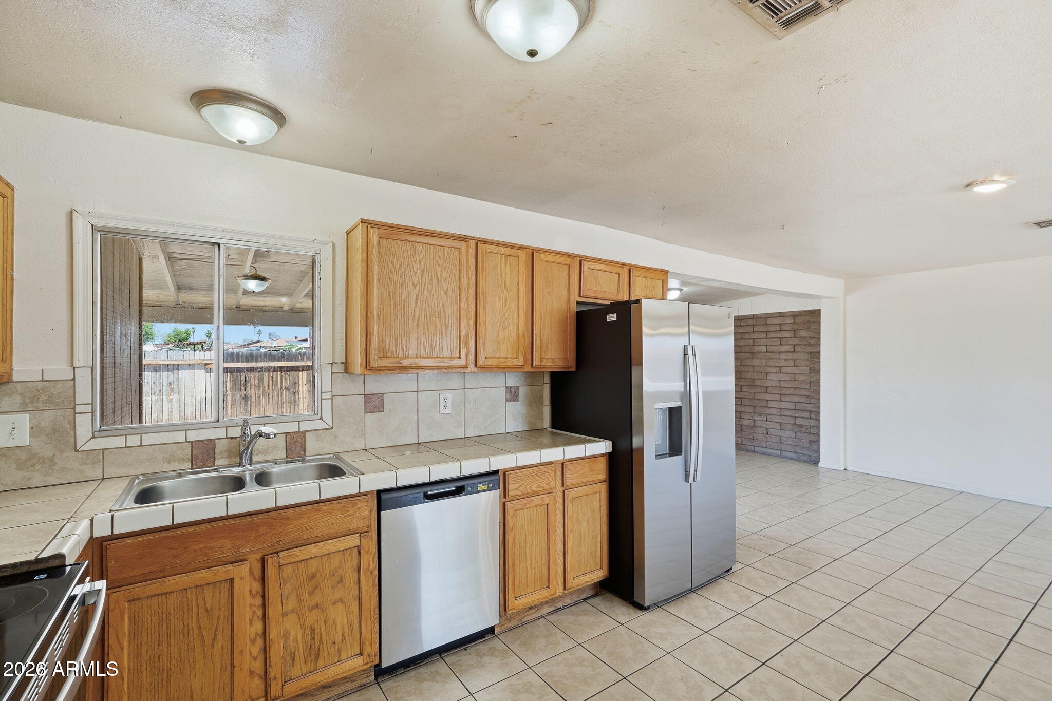 6452 West Thomas Road Phoenix, AZ 85033 - Photo 11 of 30 a kitchen with a sink cabinets and window