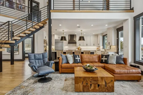 a large living room with furniture and a chandelier