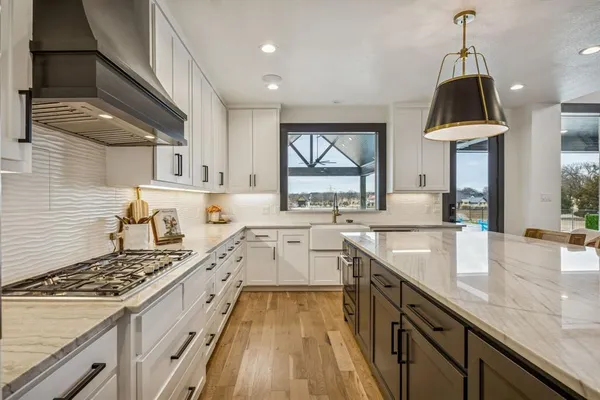 a kitchen with sink stove and cabinets