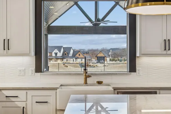 a bathroom with a granite countertop sink and a large mirror