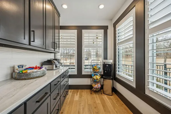 a kitchen with sink refrigerator and wooden floor