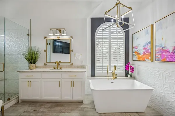 a bathroom with a sink mirror and a bathtub