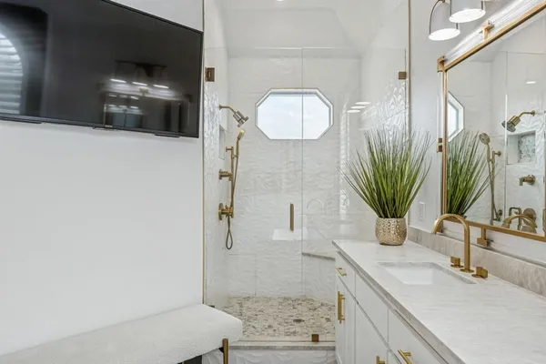a bathroom with a sink a mirror and shower