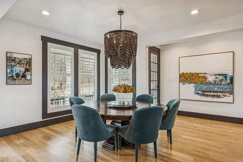 a large living room with furniture and a chandelier