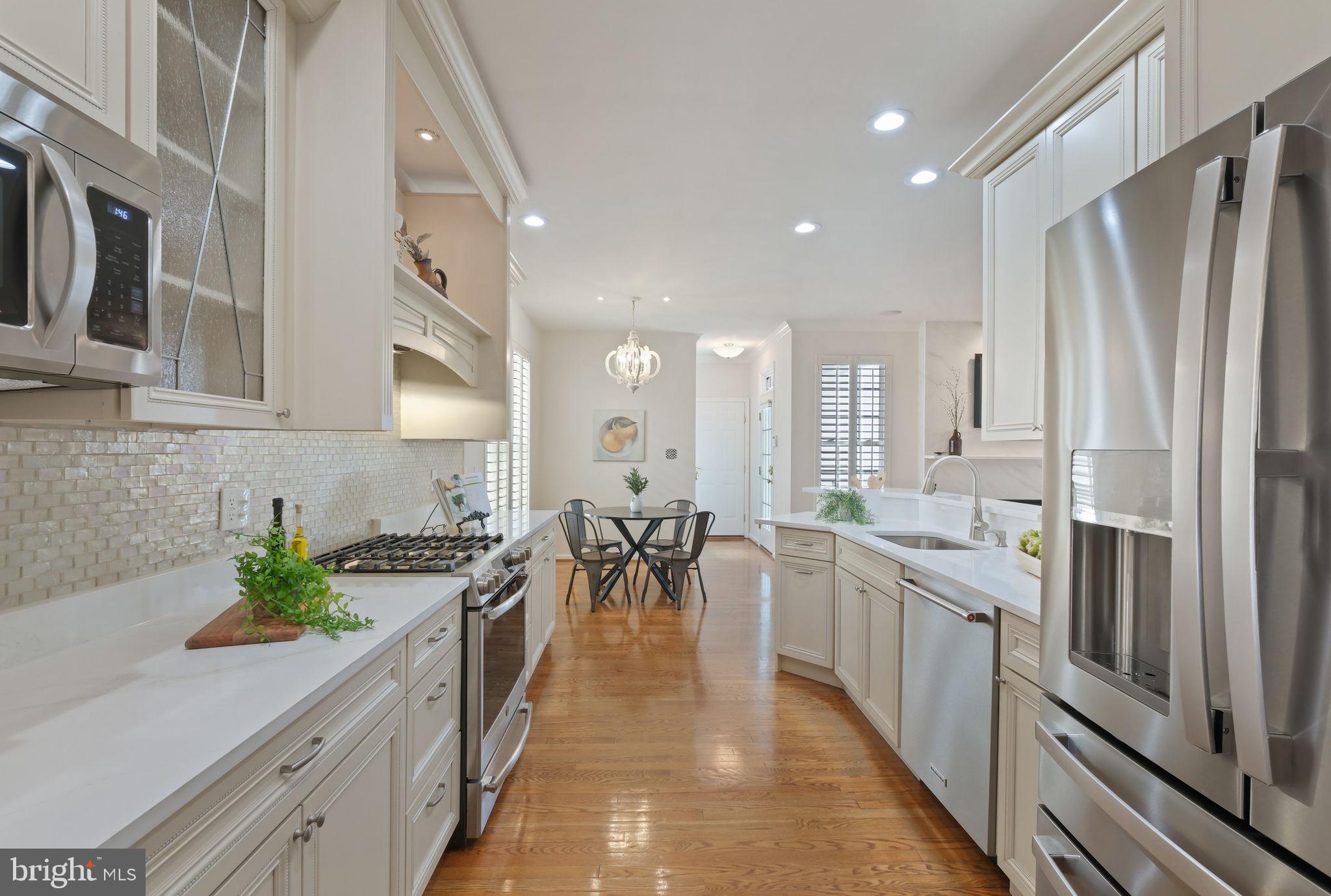 520 Kersten Street Gaithersburg, MD 20878 - Photo 14 of 63 a large white kitchen with lots of counter space and stainless steel appliances