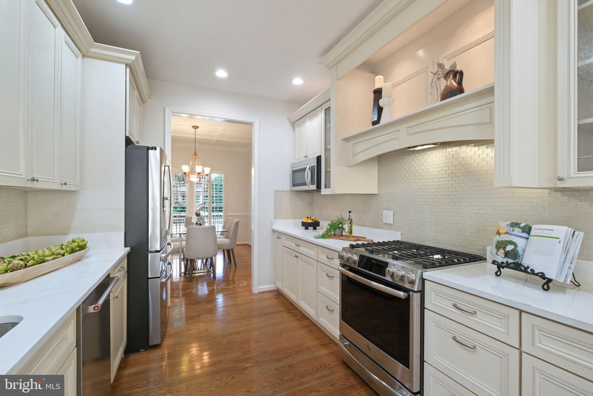 520 Kersten Street Gaithersburg, MD 20878 - Photo 16 of 63 a kitchen with stainless steel appliances a stove a sink cabinets and a refrigerator