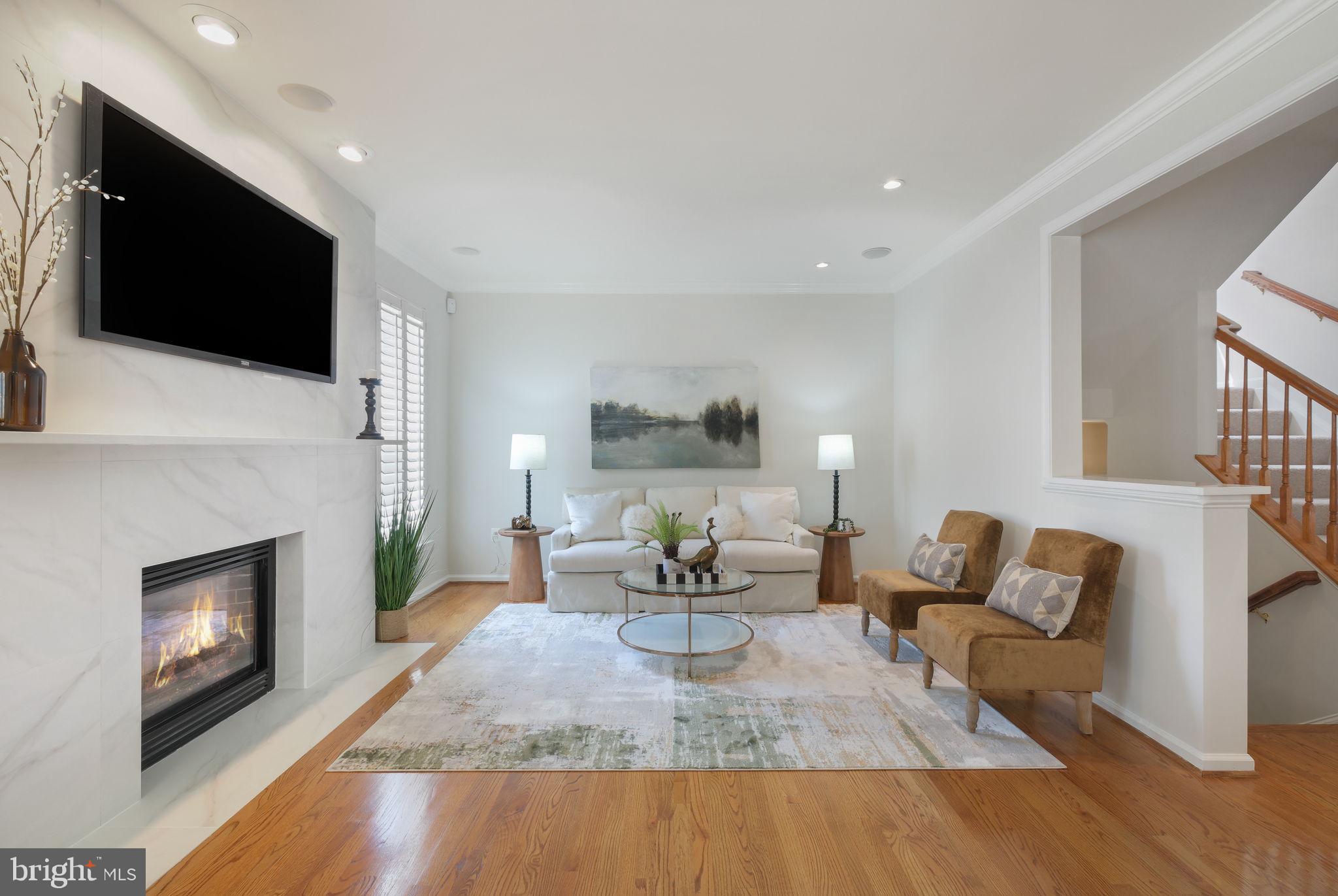 520 Kersten Street Gaithersburg, MD 20878 - Photo 20 of 63 a living room with furniture a fireplace and a flat screen tv