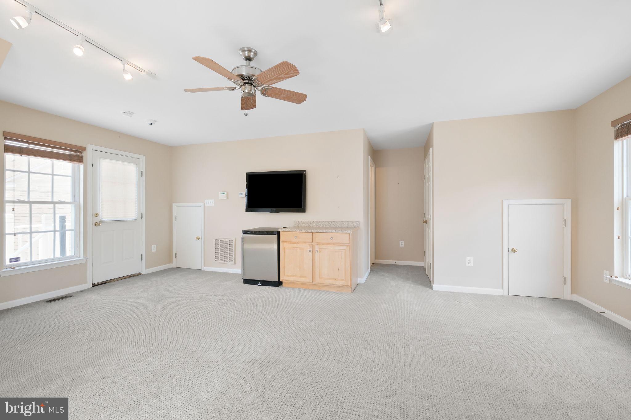 520 Kersten Street Gaithersburg, MD 20878 - Photo 41 of 63 a view of an empty room with a ceiling fan and window