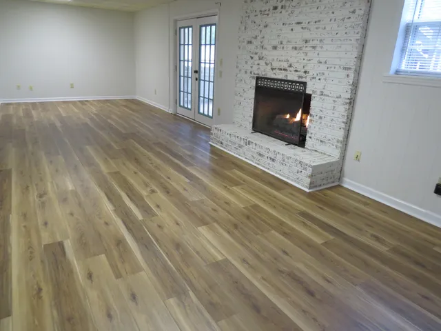 wooden floor and fireplace in empty room