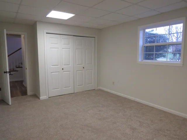 an empty room with windows and closet