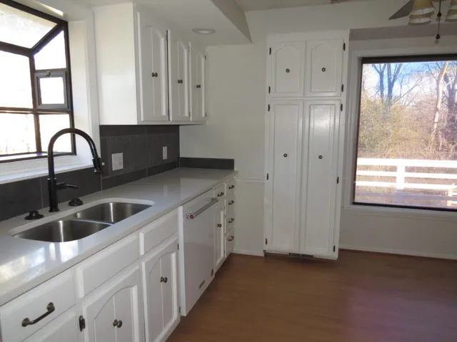 a kitchen with granite countertop a sink and a window