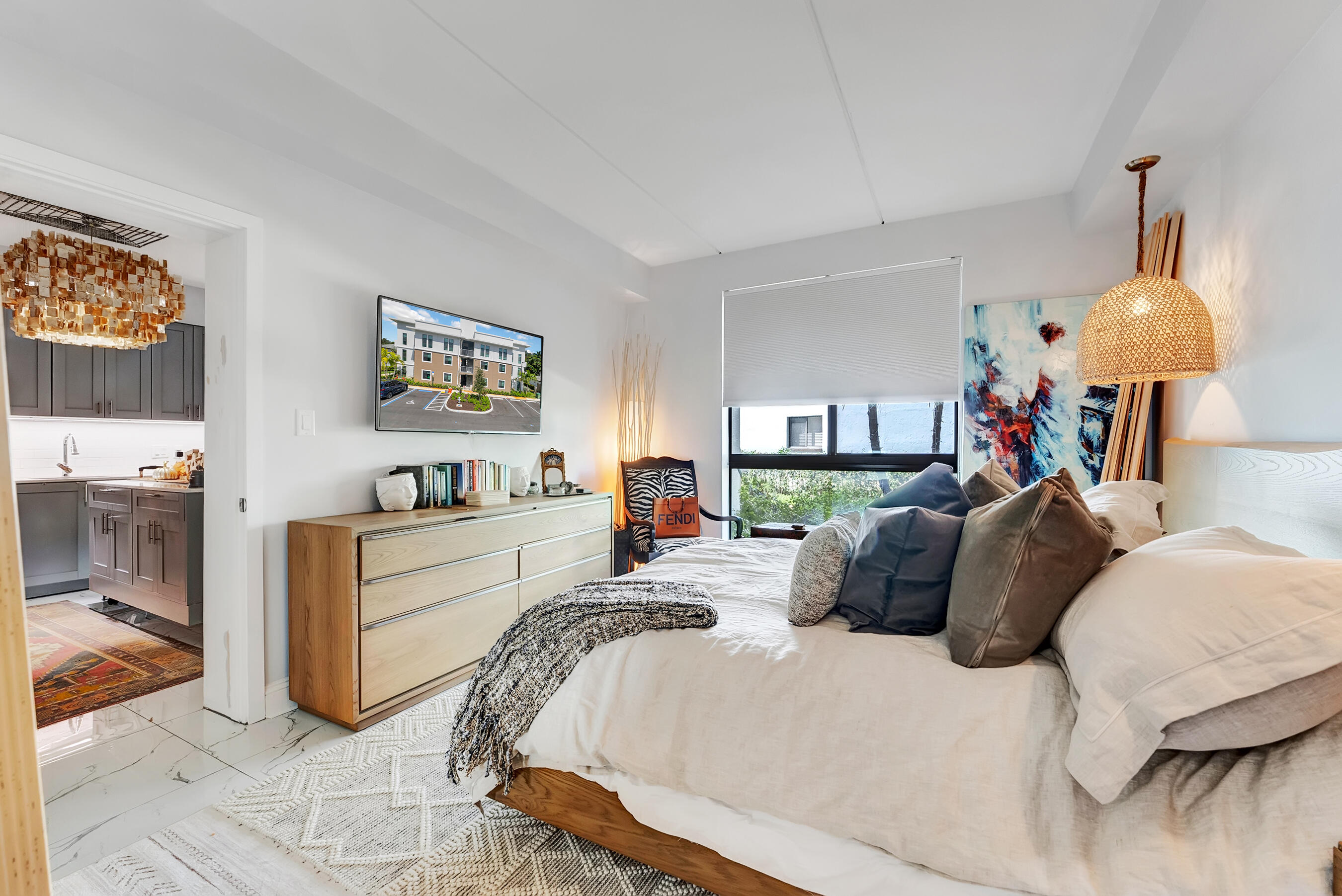 250 West Hidden Valley Boulevard, Unit 3 Boca Raton, FL 33487 - Photo 11 of 27 a bed room with a bed mirror and wall painting