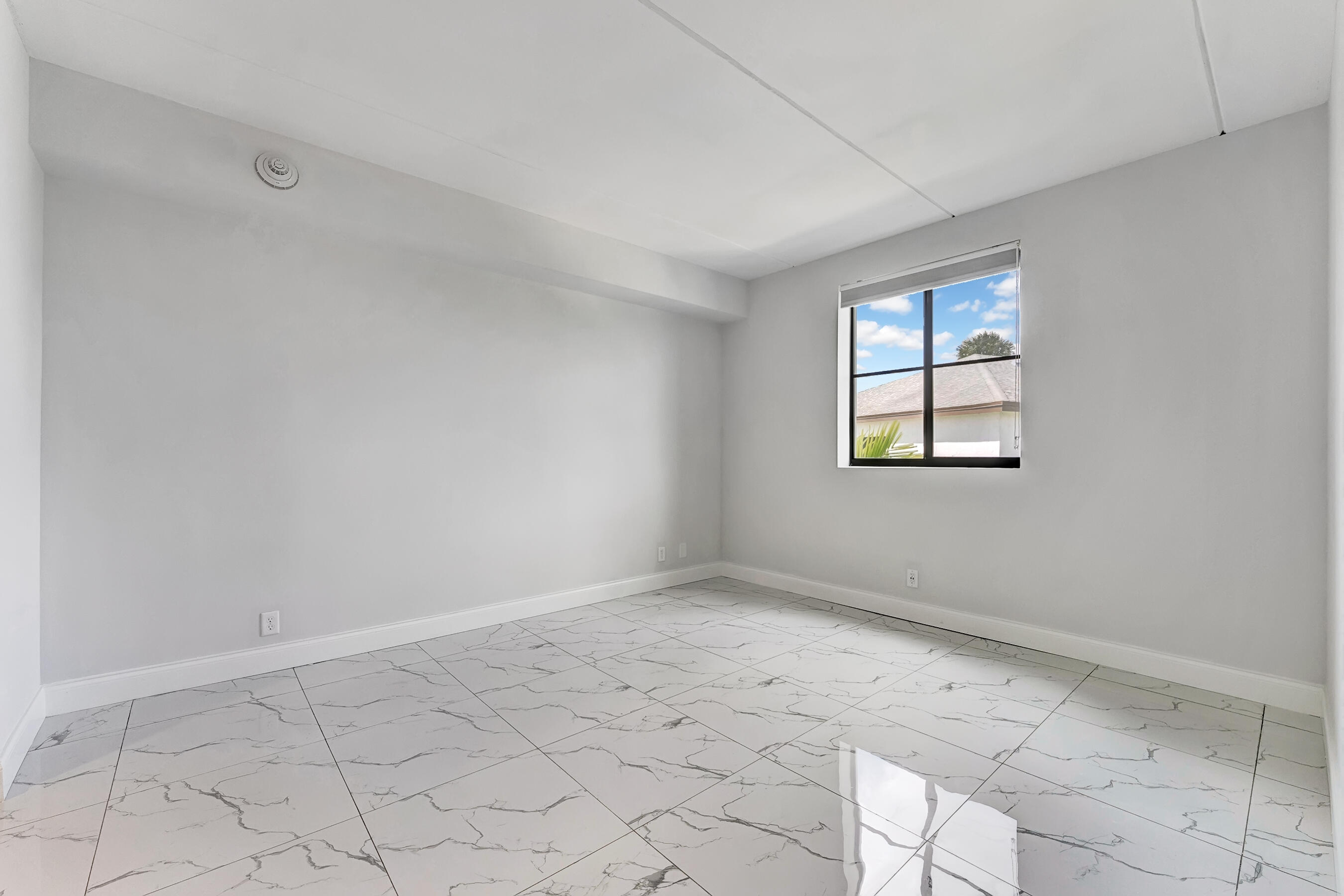 250 West Hidden Valley Boulevard, Unit 3 Boca Raton, FL 33487 - Photo 15 of 27 an empty room with windows