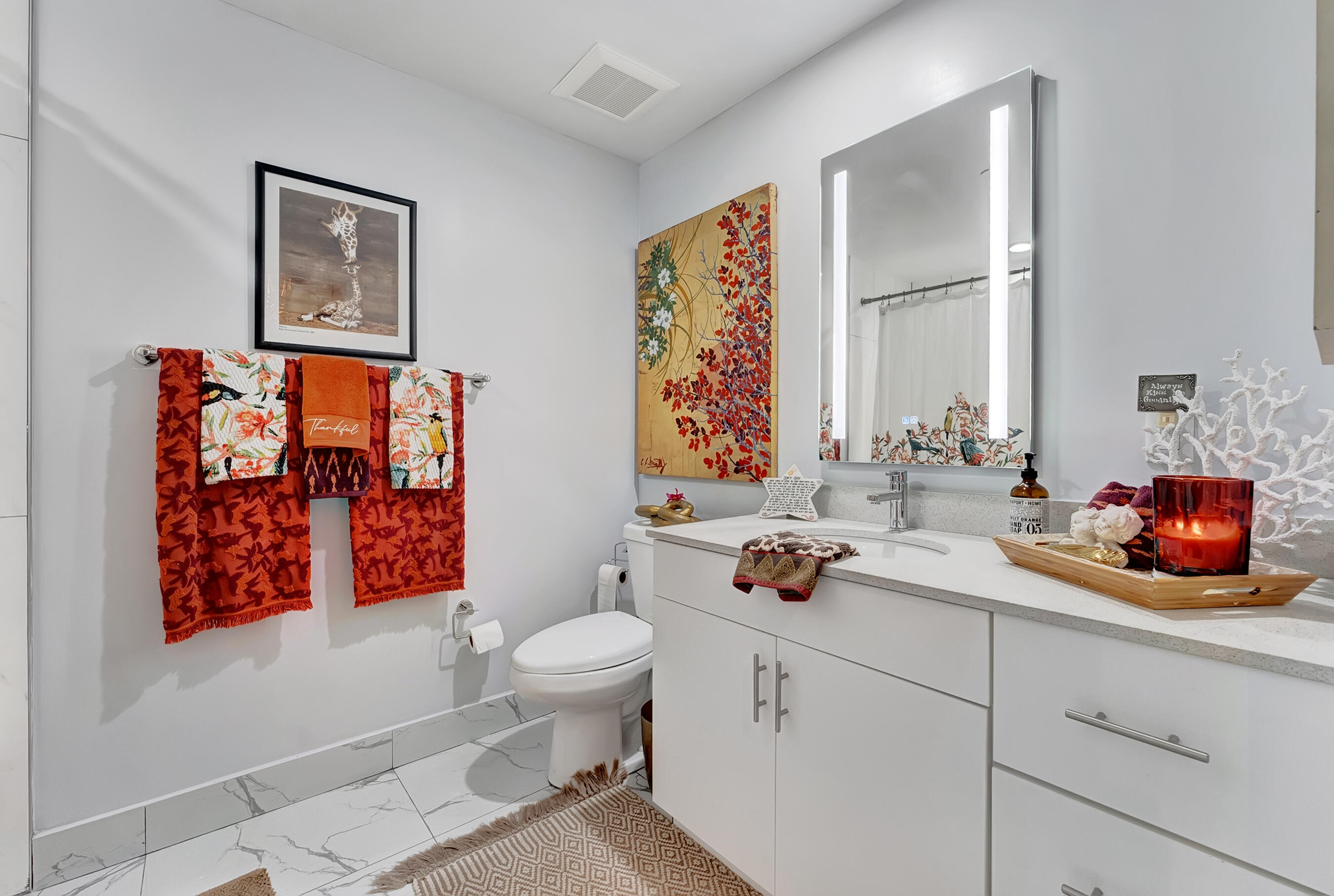 250 West Hidden Valley Boulevard, Unit 3 Boca Raton, FL 33487 - Photo 16 of 27 a bathroom with a toilet sink and mirror