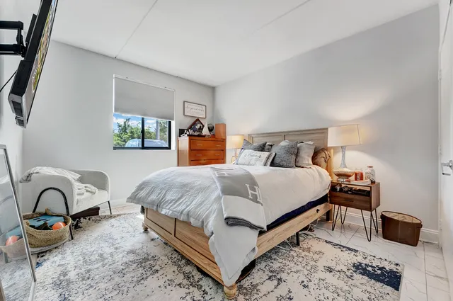 a bedroom with bed and a window