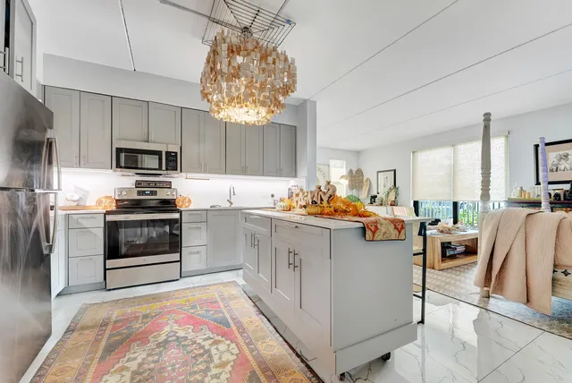 a kitchen with cabinets and stainless steel appliances