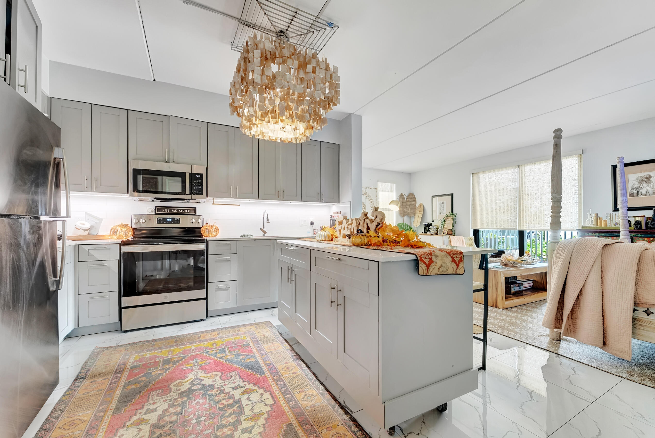 250 West Hidden Valley Boulevard, Unit 3 Boca Raton, FL 33487 - Photo 2 of 27 a kitchen with cabinets and stainless steel appliances
