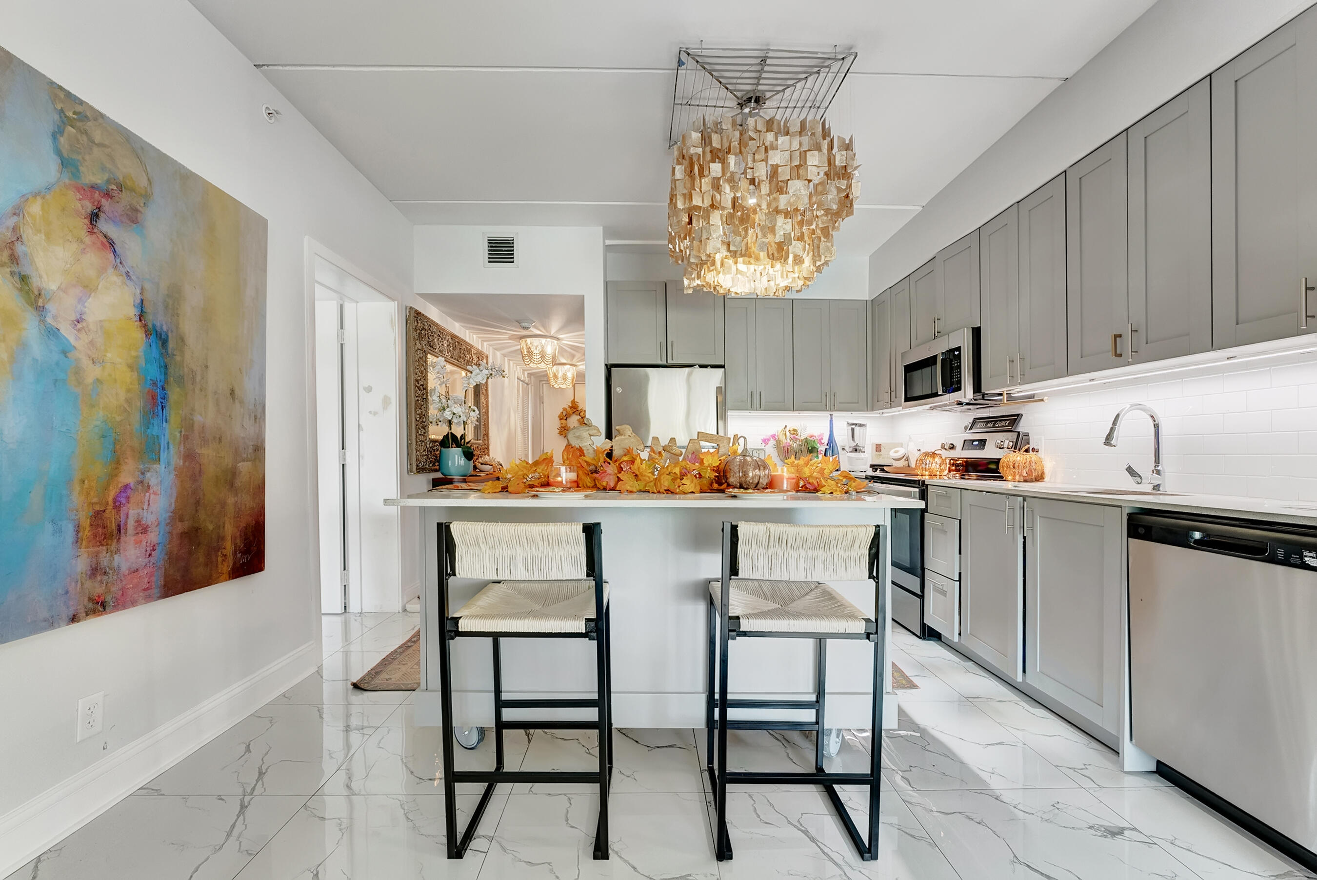 250 West Hidden Valley Boulevard, Unit 3 Boca Raton, FL 33487 - Photo 4 of 27 a kitchen with stainless steel appliances granite countertop a refrigerator and a stove top oven