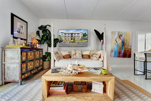 a living room with furniture and book shelf