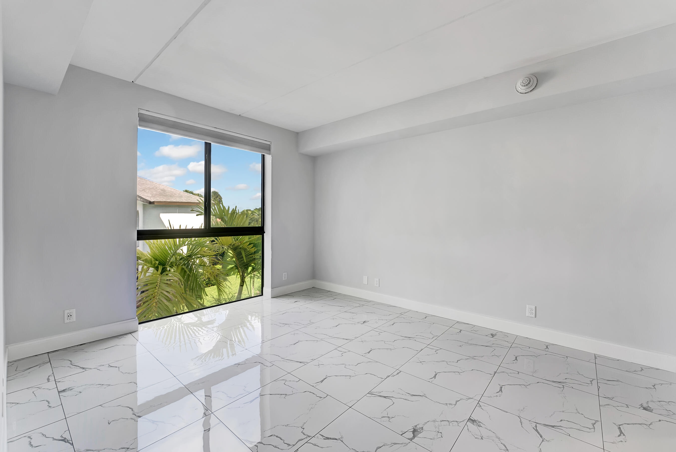 250 West Hidden Valley Boulevard, Unit 3 Boca Raton, FL 33487 - Photo 10 of 27 an empty room with windows