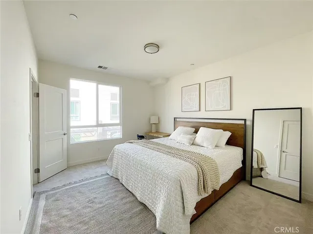 a bedroom with a bed and a window