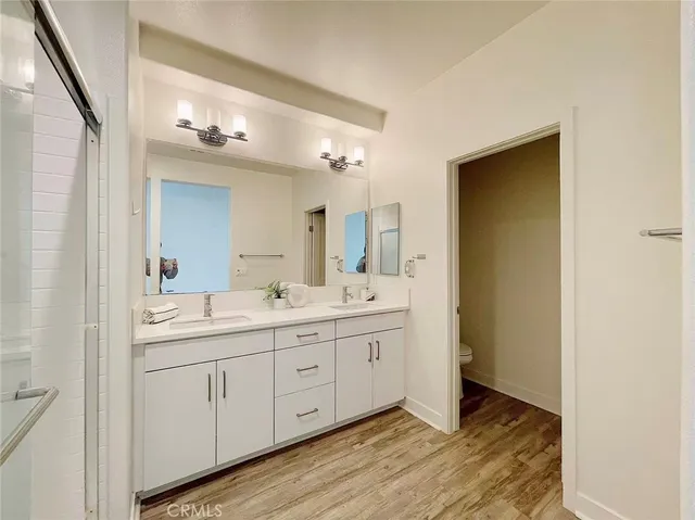 a spacious bathroom with a double vanity sink and a mirror