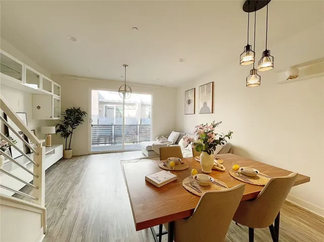a view of a dining room with furniture wooden floor and chandelier