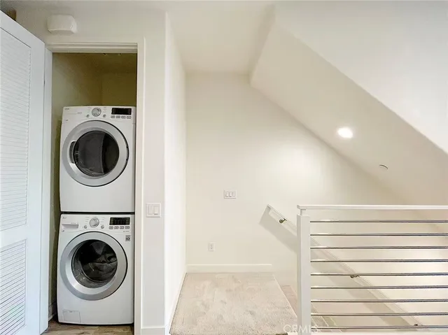 a view of a hallway with washer and dryer