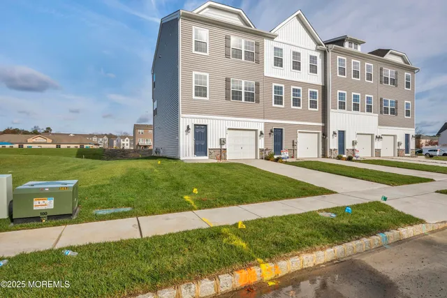 a front view of a building with a yard