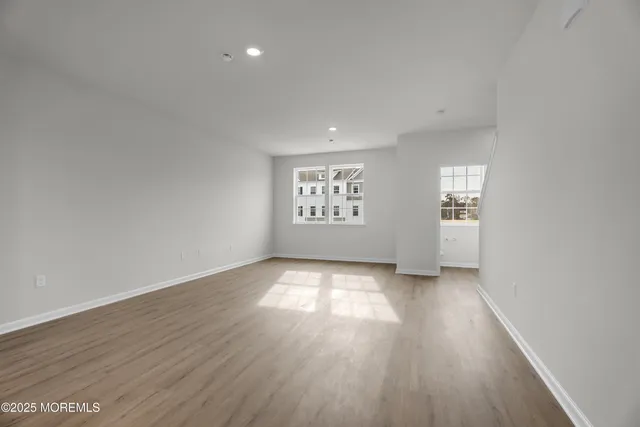 an empty room with windows and closet