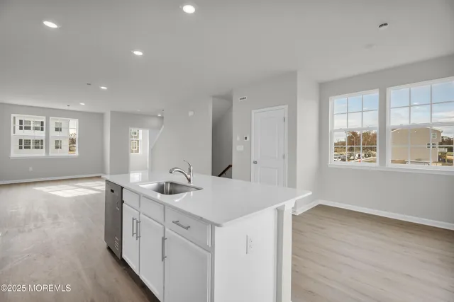 a kitchen with stainless steel appliances a sink dishwasher stove microwave and cabinets