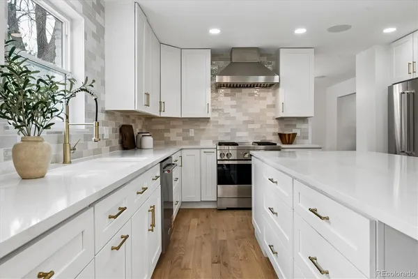 a kitchen with granite countertop white cabinets and white appliances