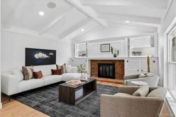 a living room with furniture and a fireplace