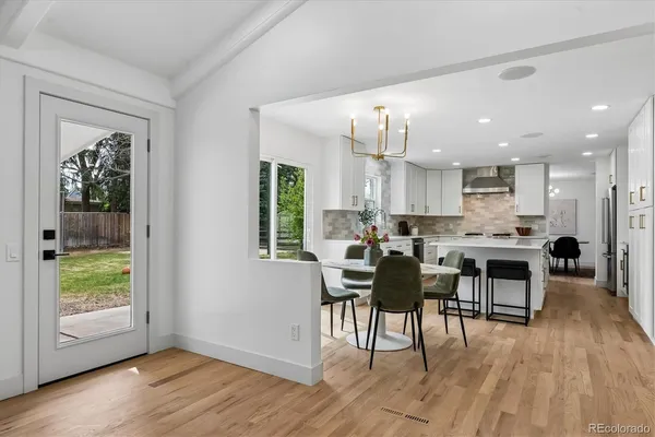 a view of kitchen with refrigerator and wooden floor