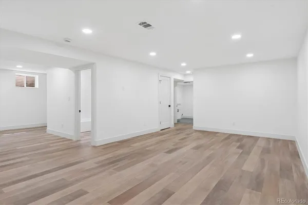 a view of an empty room with wooden floor