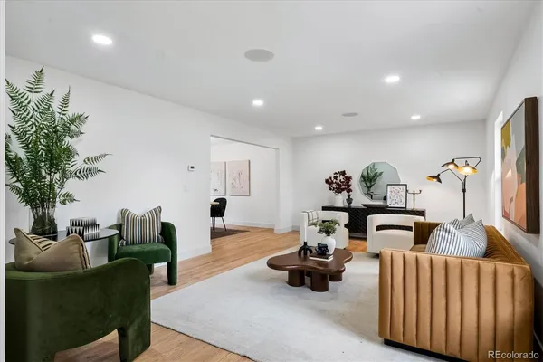 a living room with furniture and flowers