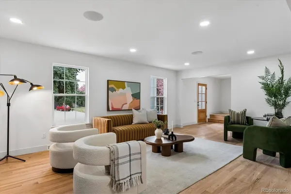 a living room with furniture and wooden floor