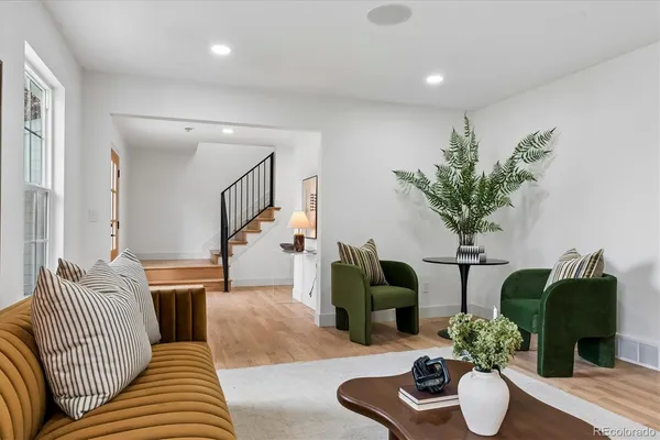 a living room with furniture potted plant and a lamp