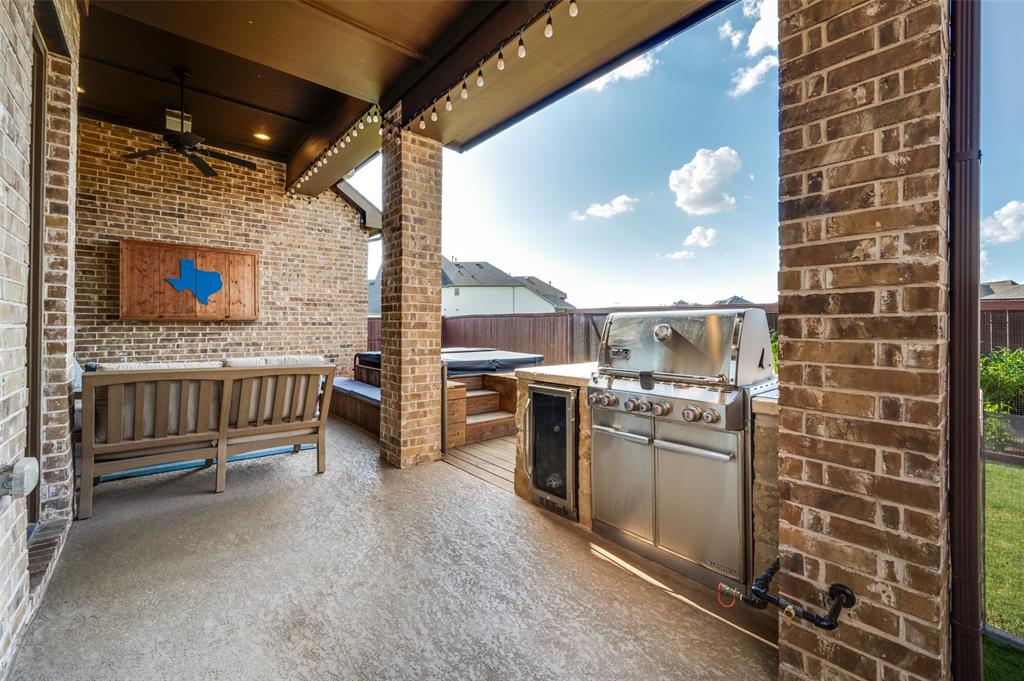 2721 Old Shire Path Road Prosper, TX 75078 - Photo 34 of 40 Covered patio featuring a built-in outdoor kitchen with a stainless steel grill, a compact refrigerator, a ceiling fan, and string lighting
