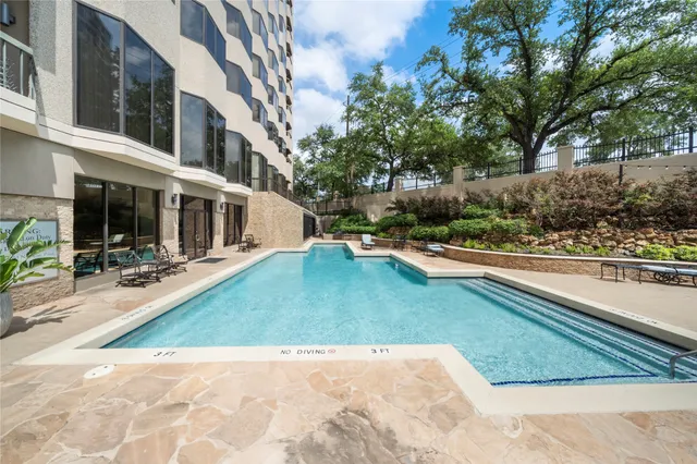 a view of a swimming pool with a patio