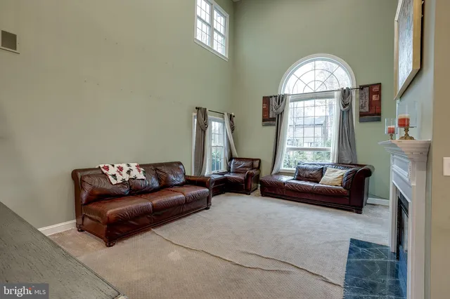 a living room with furniture a flat screen tv and a window