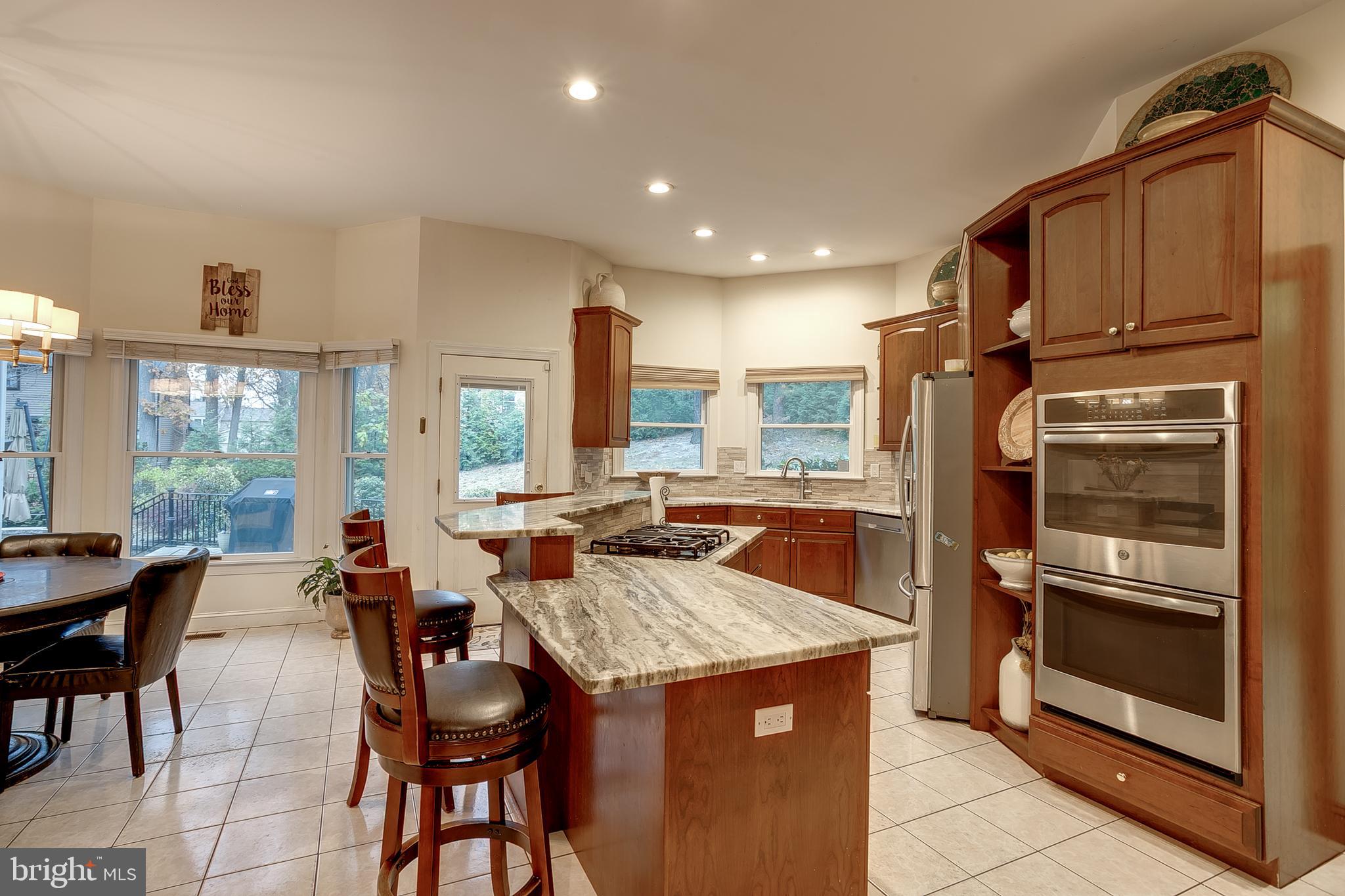 6 Oak Ridge Drive Voorhees, NJ 08043 - Photo 15 of 52 a kitchen with granite countertop kitchen island wooden cabinets and stainless steel appliances