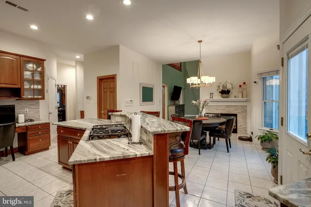 a kitchen with stainless steel appliances a dining table chairs and chandelier