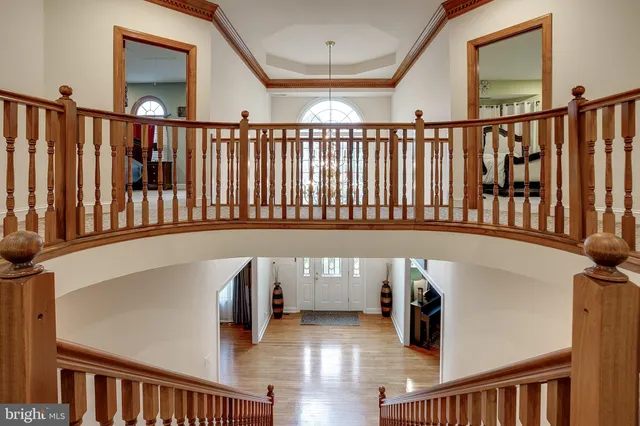 a view of staircase with railing and a large window