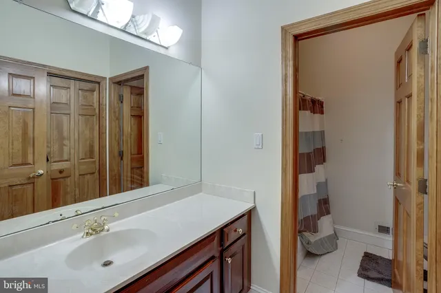 a spacious bedroom with a bed and a flat screen television