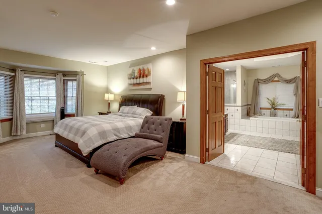 a bedroom with a bed and a lamp on dresser