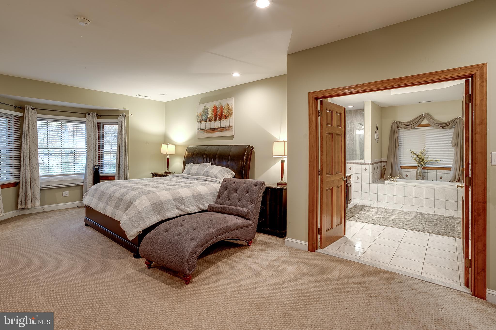 6 Oak Ridge Drive Voorhees, NJ 08043 - Photo 28 of 52 a bedroom with a large bed and a mirror