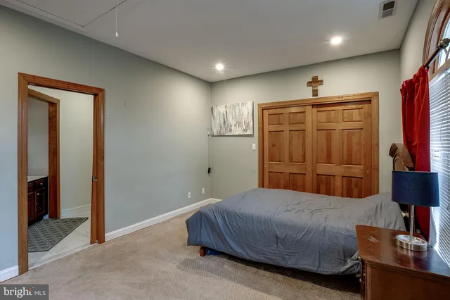 a bedroom with a bed lamp and a window