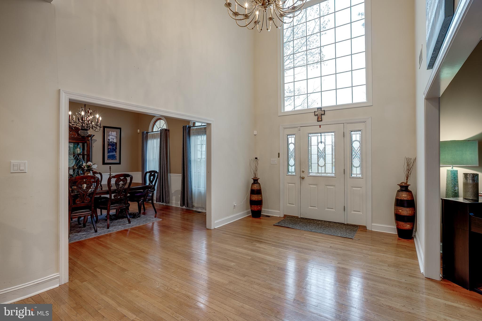 6 Oak Ridge Drive Voorhees, NJ 08043 - Photo 6 of 52 an empty room with wooden floor and windows