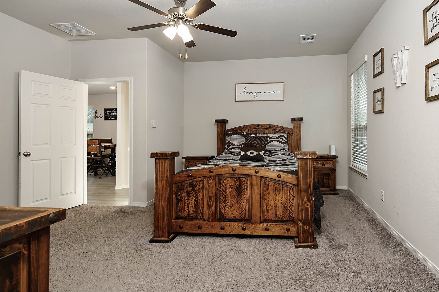26324 Cooperstown Way Splendora, TX 77372 - Photo 13 of 23 a bedroom with a bed and a chandelier